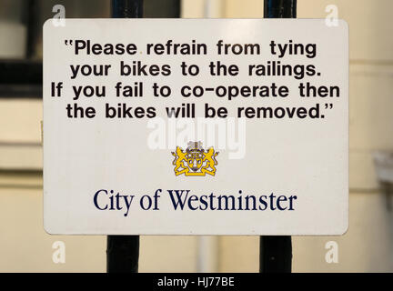 Local council sign warning of removal if bicycles attached to railings, London, UK Stock Photo