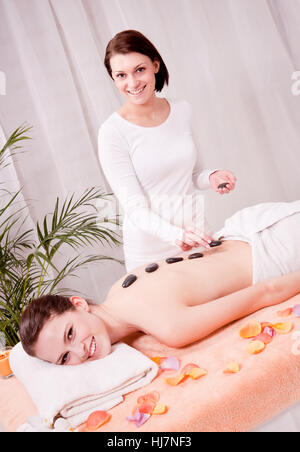 young attraktve woman gets a hot stone massage Stock Photo