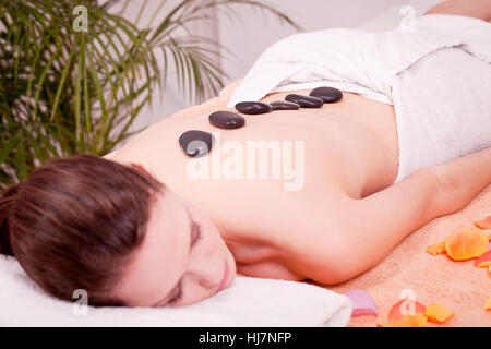 young attraktve woman gets a hot stone massage Stock Photo