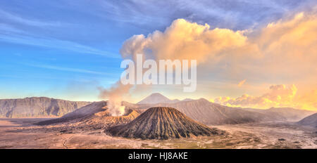 Smoking volcano Gunung Bromo, Mount Batok in front, Mount Kursi at back, Mount Gunung Semeru, Bromo Tengger Semeru National Park Stock Photo