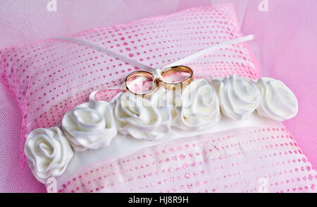 Two wedding rings on a ring pillow Stock Photo