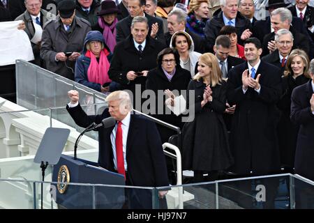 President Donald Trump holds his fist in victory to the crowd following his Inaugural address after being sworn-in as the 45th President on Capitol Hill January 20, 2017 in Washington, DC. Stock Photo