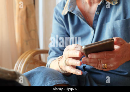 older woman using smart phone Stock Photo