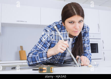 Female plumber installing faucet Stock Photo
