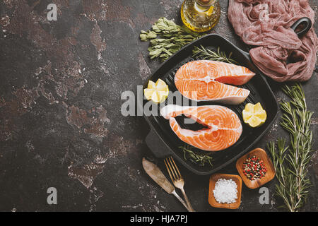 Grill frying pan with slice of salmon and herbs, closeup Stock Photo ...