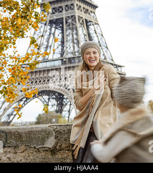 Autumn getaways in Paris with family. happy mother and daughter tourists on embankment in Paris, France playing outside Stock Photo