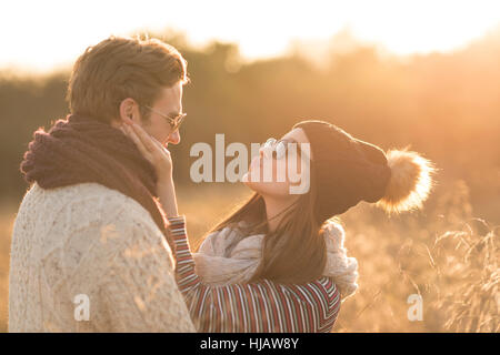 Young couple in rural setting, fooling around, face to face Stock Photo