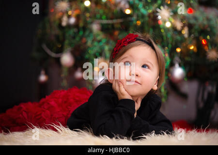 Beautiful Little Girl Looking Up Expecting Her Christmas Gifts Stock Photo