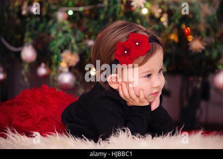 Beautiful Little Girl Under the Christmas Tree Stock Photo