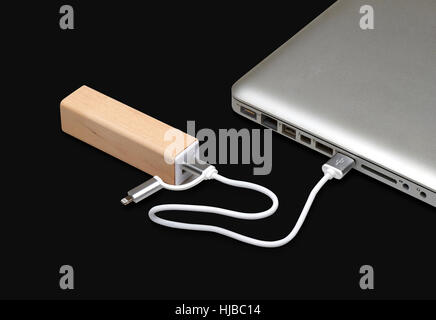 Wooden portable external power bank, for emergency phone recharge isolated on black with clipping path Stock Photo
