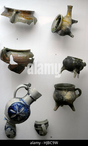 Polish pottery. Fragments of kitchen utensils of three-legged pots and pans and flat bottom pots. 17th-18th century. Archaeological Museum of Gdansk. Poland. Europe Stock Photo