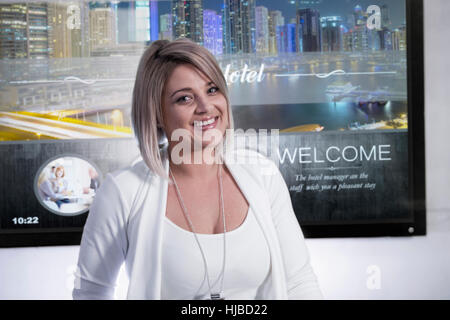 Portrait of female receptionist at hotel reception desk Stock Photo