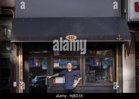 Portrait of barman outside public house window, Brooklyn, New York, USA Stock Photo