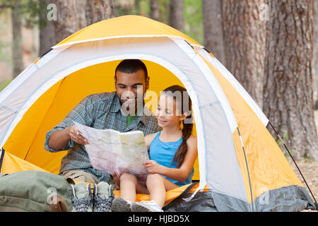 Young man and girl in dome tent looking at map, Sedona, Arizona, USA Stock Photo