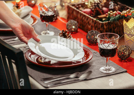 Woman preparing festive place setting Stock Photo