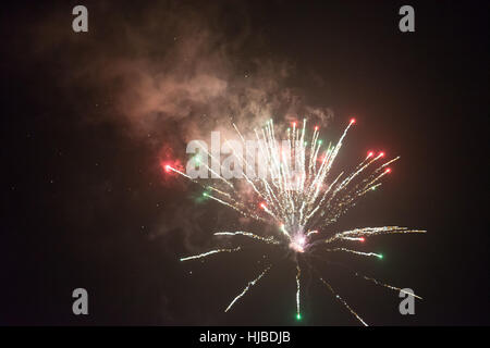 Fireworks on the dark nightly sky with smoke Stock Photo