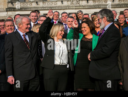 (left to right) Former Deputy First Minister Martin McGuiness raises the hand of newly appointed Sinn Fein Stormont leader Michelle O'Neill with Mary Lou McDonald and Gerry Adams as colleagues look on, on the steps of Parliament Buildings Stormont. Stock Photo