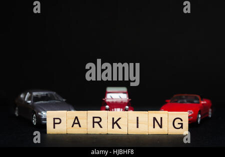 PARKING word written on wood blocks and toys cars in background Stock Photo