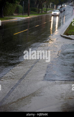 Car driving in rain on wet streets Stock Photo