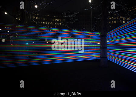 London, UK. 23rd Jan, 2017. Horizontal Interference at Winter Lights Canary Wharf, made by Joachim Slugocki and Katarzyna Malejka, two artists from Poland. It is composed by a modular site-specific installation links the tops of trees with streams of light. Credit: Alberto Pezzali/Pacific Press/Ģ����ý Live News Stock Photo