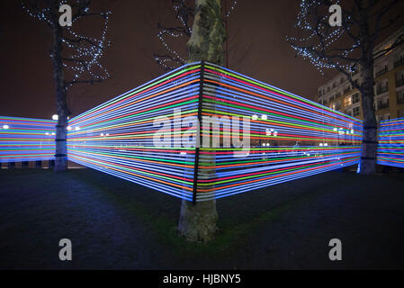 London, UK. 23rd Jan, 2017. Horizontal Interference at Winter Lights Canary Wharf, made by Joachim Slugocki and Katarzyna Malejka, two artists from Poland. It is composed by a modular site-specific installation links the tops of trees with streams of light. Credit: Alberto Pezzali/Pacific Press/Ģ����ý Live News Stock Photo
