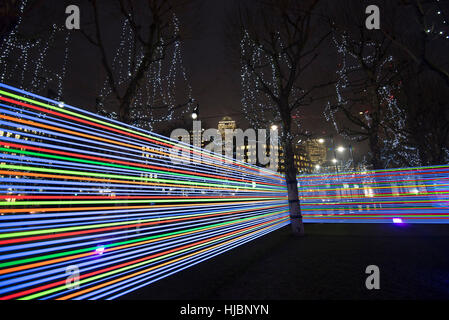 London, UK. 23rd Jan, 2017. Horizontal Interference at Winter Lights Canary Wharf, made by Joachim Slugocki and Katarzyna Malejka, two artists from Poland. It is composed by a modular site-specific installation links the tops of trees with streams of light. Credit: Alberto Pezzali/Pacific Press/Ģ����ý Live News Stock Photo