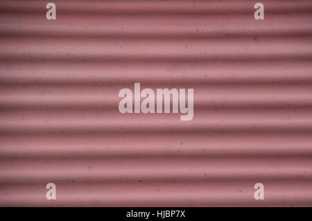 Image is filled with pink and white striped undulated curvy waves from a harborside warning sign. Stock Photo