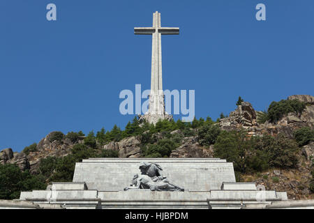 The Holy Cross over the Basilica de la Santa Cruz (Basilica of the Holy Cross) in the Valle de los Caidos (Valley of the Fallen) near Madrid, Spain. The Pieta by Spanish sculptor Juan de Avalos in seen in the foreground. Stock Photo