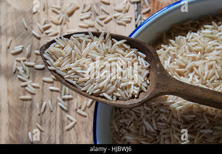 brown indian basmati rice in a white metal bowl Stock Photo