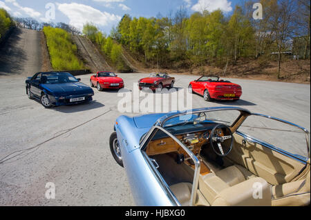 Open top classic sports cars from the 60s, 70s, 80s, 90s and 00s, in that order: Lotus Elan, MGB, Toyota MR2, Mazda MX5 and MGF Stock Photo