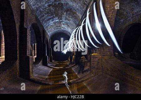 Using lights and smoke to create an atmospheric image of Finsbury Park Underground Reservoir, North London. Stock Photo