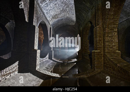 Using lights and smoke to create an atmospheric image of Finsbury Park Underground Reservoir, North London. Stock Photo