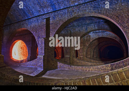 Spinning ignited wire wool to create an atmospheric image in Finsbury Park Underground Reservoir, North London. Stock Photo