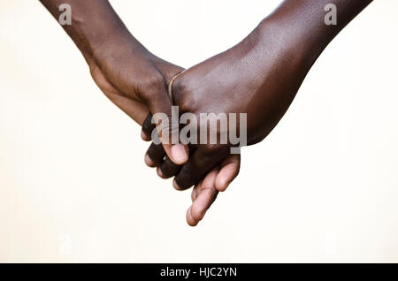 Friendship Symbol: Black People Holding Hands Together. Symbol for fight against racism, peace for the world! Stock Photo