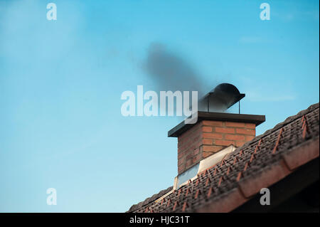 Chimney with a smoke coming out. Stock Photo