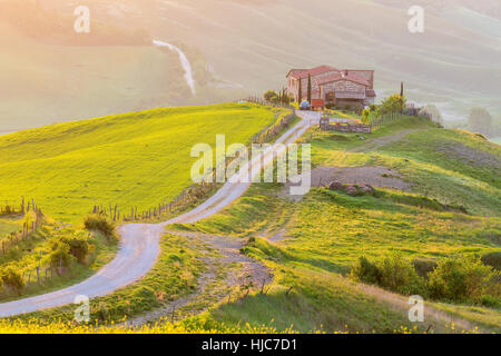Italian farm on a hill in the morning light in Toscany Stock Photo