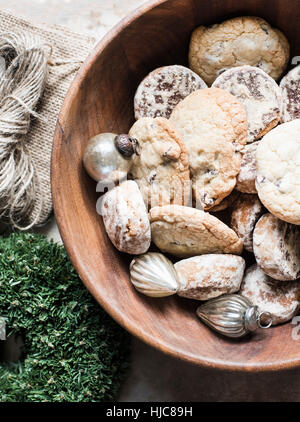 Overhead view of silver Christmas baubles and fresh cookies in bowl Stock Photo