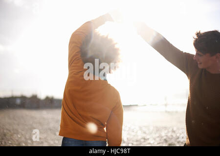 Couple dancing on beach Stock Photo