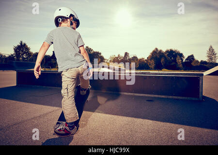 Boy skateboarding in park Stock Photo