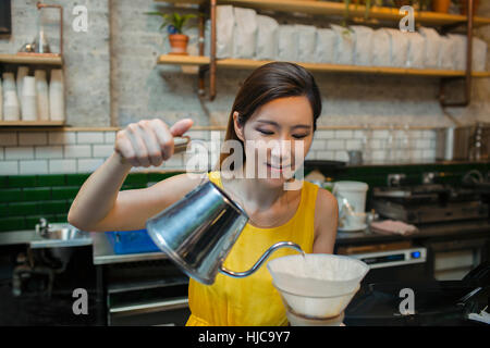 Female barista preparing filter coffee in cafe Stock Photo