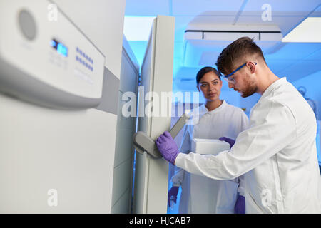 Scientists in laboratory using scientific equipment Stock Photo
