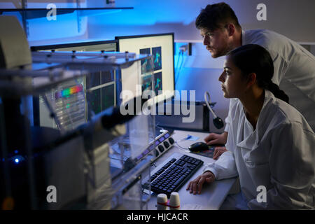 Scientists in laboratory using computer Stock Photo