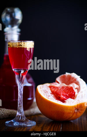 sweet grapefruit alcoholic cordial in the decanter with a glass Stock Photo