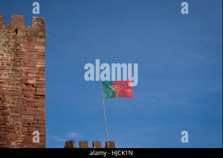 Portuguese flag flying blue sky Stock Photo