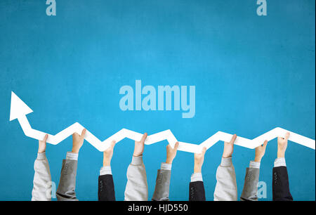 Group of business people holding growing graph in raised hands Stock ...