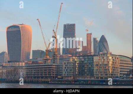 London, UK. 24th January, 2017. UK Weather. In spite of fog forecasts, central London wakens up to a frosty and golden sunrise colouring skyscrapers in the City of London, seen from the South Bank in January 2017. © Malcolm Park editorial/Alamy Live News. Stock Photo