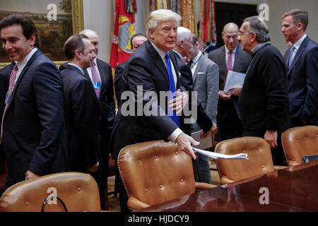 Washington, USA. 24th Jan, 2017. NO WIRE SERVICE. Washington, DC, USA. 24th Jan, 2017. US President Donald Trump takes his seat prior to delivering remarks to automobile industry leaders during a meeting in the Roosevelt Room of the White House in Washington, DC, USA. Credit: Shawn Thew/Pool via CNP/dpa/Alamy Live News Stock Photo
