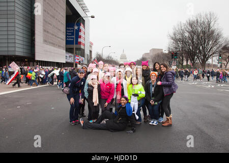 Washington, USA. January 21st, 2017. Women's March on Washington, DC:  Group of friends from across the country gather on Pennsylvania Avenue, NW, in front of Newseum with the 1st Amendment edged on its facade before joining hundreds of thousands of others to protest President Trump's positions on women's and other human rights. Stock Photo