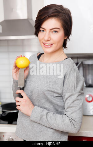 Beautiful girl with lemon , knife