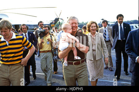 President Jimmy Carter, holds grandchild accompanied by son Jack (left) and wife Rosalynn (right) in 1979. Carter had just landed on Marine One, the presidential helicopter. Stock Photo